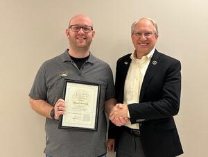 Darrin Good gives Jeremiah Ourada an award. 